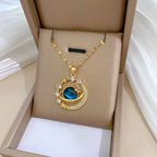 Gold-tone planet pendant necklace with blue globe centerpiece and starry halo zircon stones