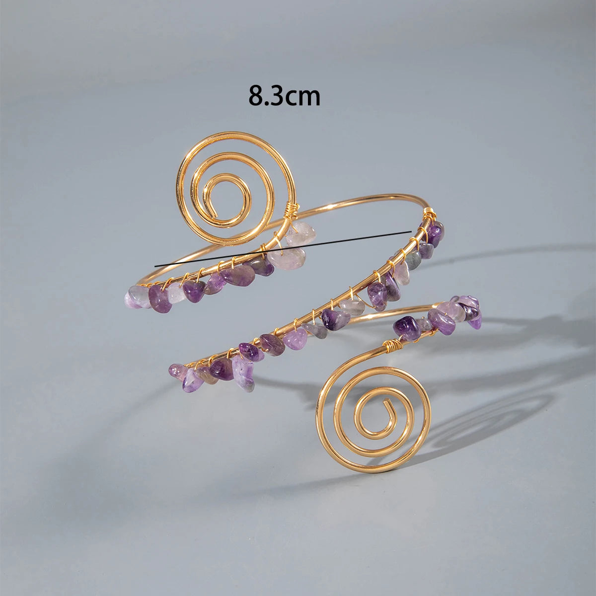 Gold-tone upper arm bracelet set with spiral wire and purple and clear stone beads