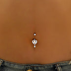 Curved barbell navel ring with small heart charm and blue opal teardrop dangle