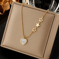 Gold-tone heart pendant and star charm chain necklace with star link detail