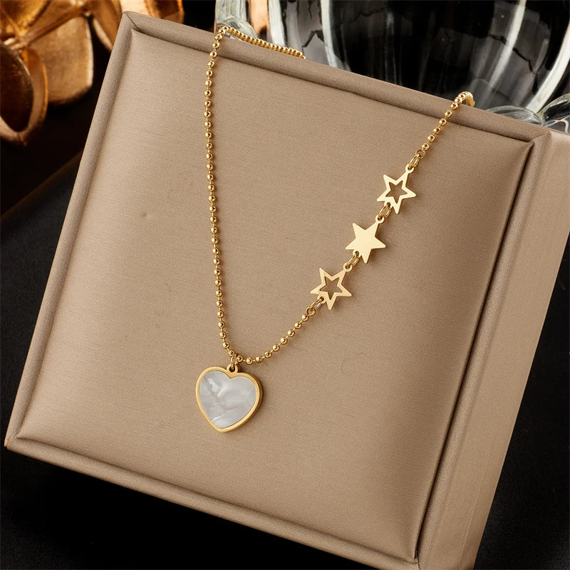 Gold-tone heart pendant and star charm chain necklace with star link detail