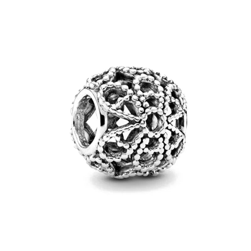 Sterling silver textured charm bead with intricate raised beadwork pattern
