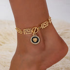 Gold embossed chain anklet with Greek-key links and round lion medallion charm