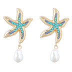 Pair of gold-tone starfish earrings with blue and turquoise crystals and white pearl drops