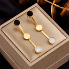 Gold-tone drop earrings with black and white round accents