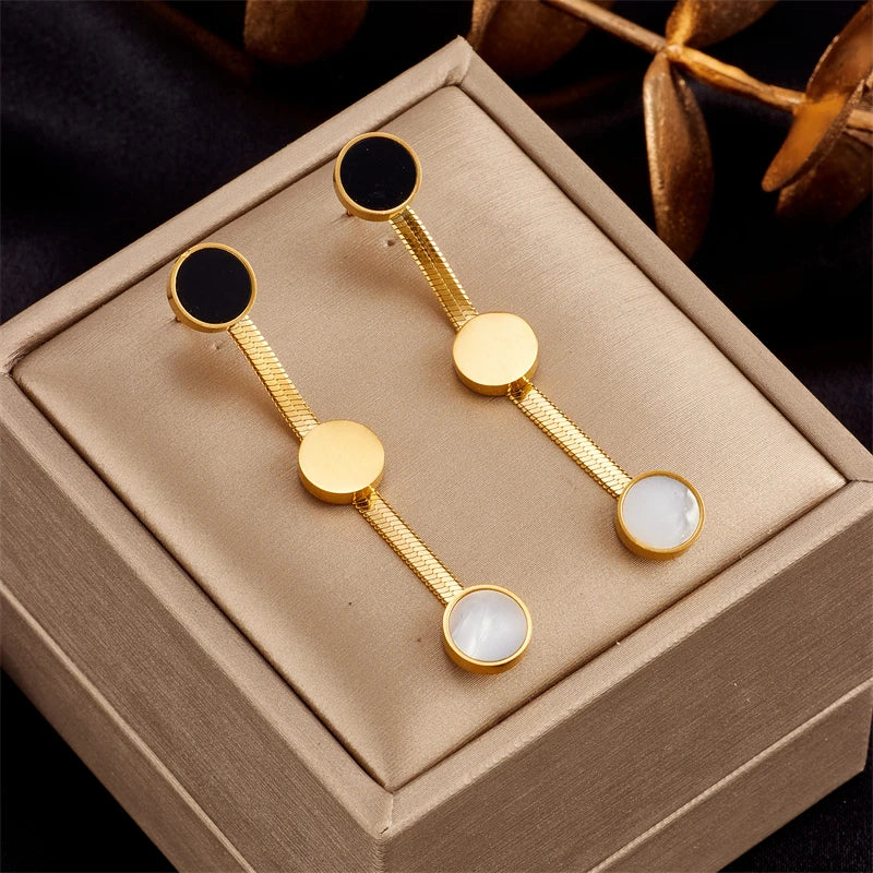 Gold-tone drop earrings with black and white round accents
