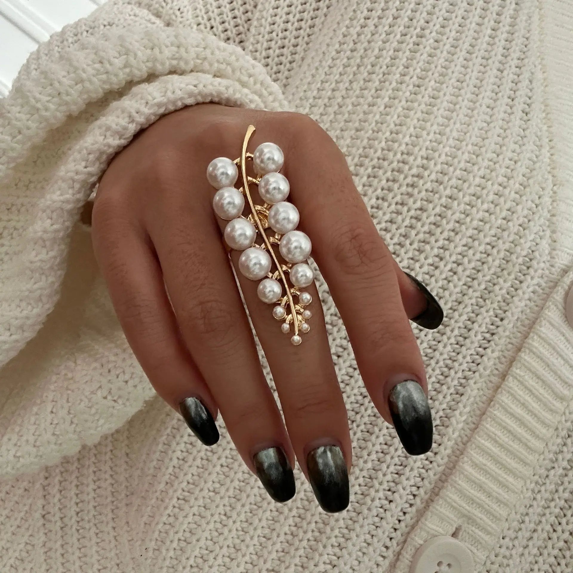 Gold starfish pearl ring with dangling pearl clusters on a slender open band