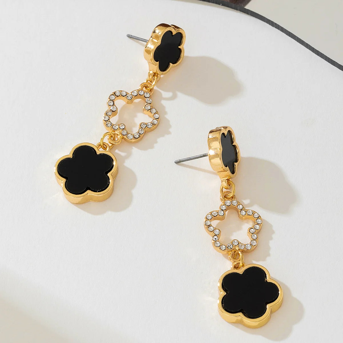 Five-petal flower long drop earrings, gold-tone with black enamel clover and crystal details