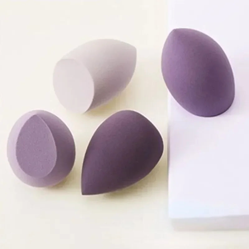 4-piece makeup sponge set with dark purple and light lavender teardrop sponges