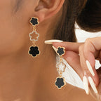 Five-petal flower long drop earrings, gold-tone with black and clear teardrop charms