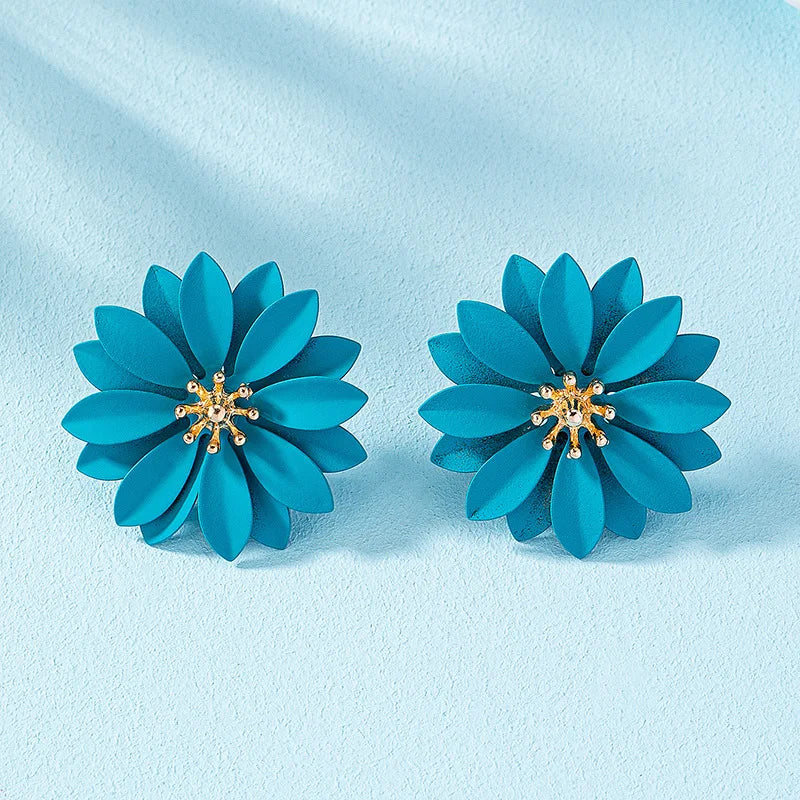 Teal enamel flower stud earrings with gold-tone center and small crystal details.