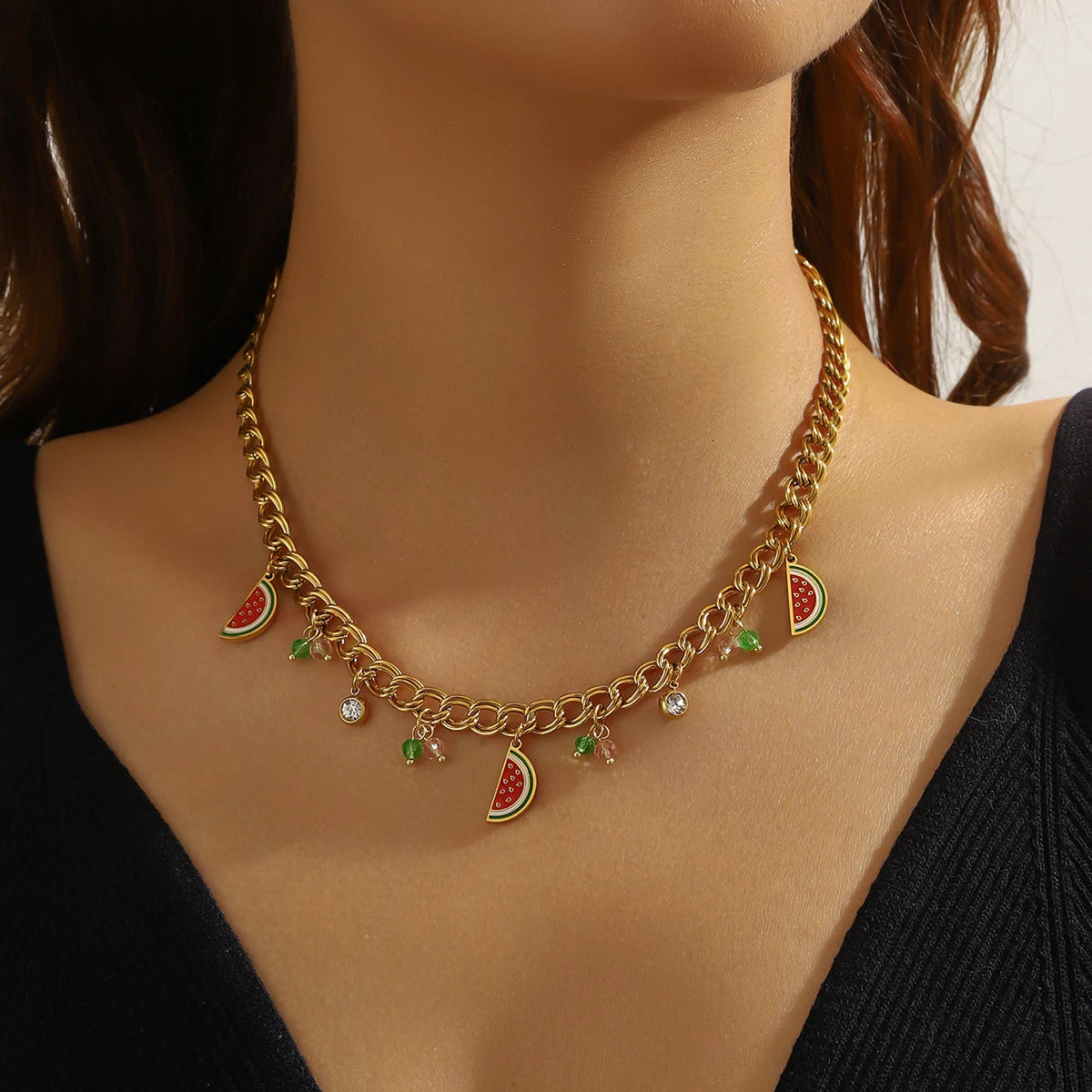 Watermelon enamel charm necklace with gold-tone chain, red-green pendants, and small stones