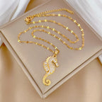 Gold-tone seahorse pendant necklace with rhinestone seahorse charm and linked chain