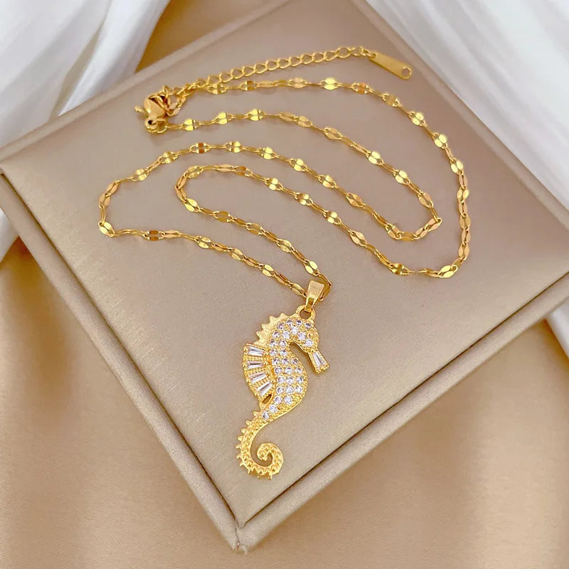 Gold-tone seahorse pendant necklace with rhinestone seahorse charm and linked chain