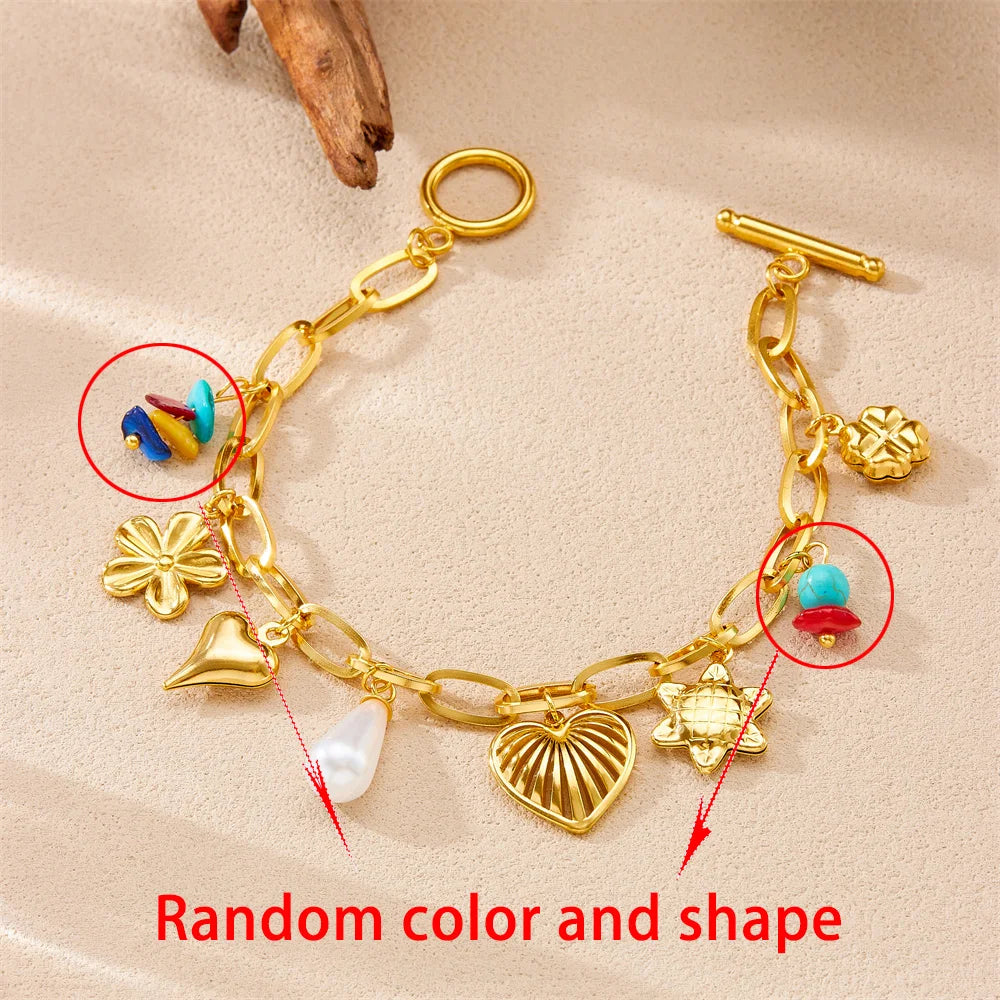 Gold-tone charm bracelet with heart, pearl, shell charms and turquoise bead accents