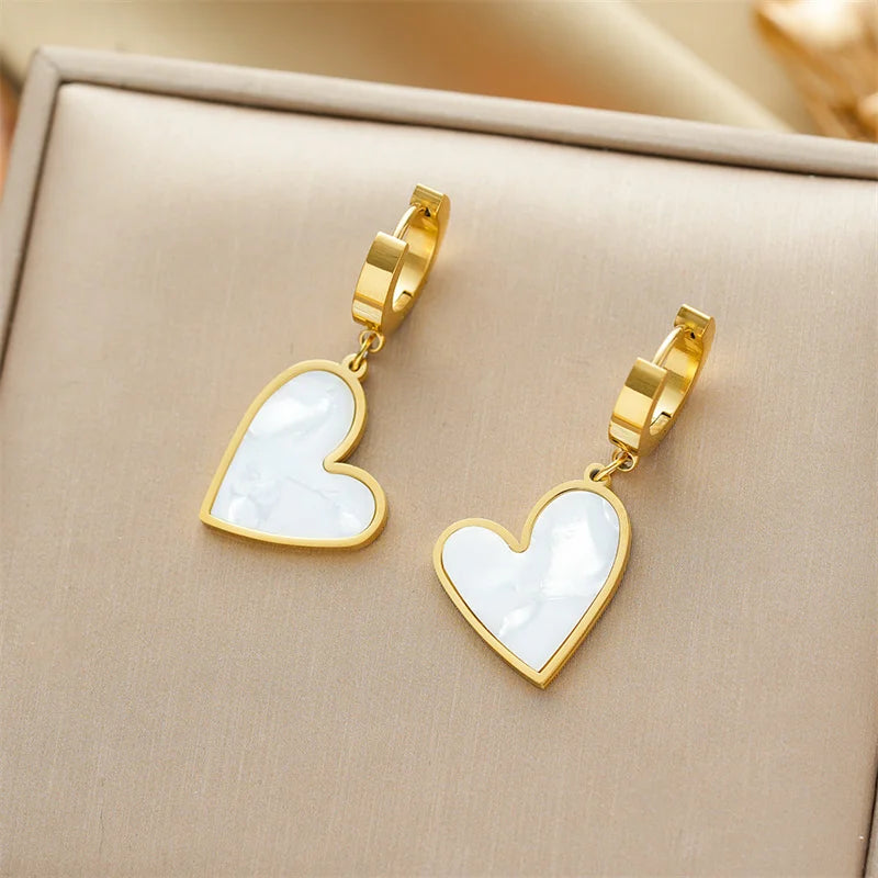 Gold-plated earrings set with white heart shell drop charms
