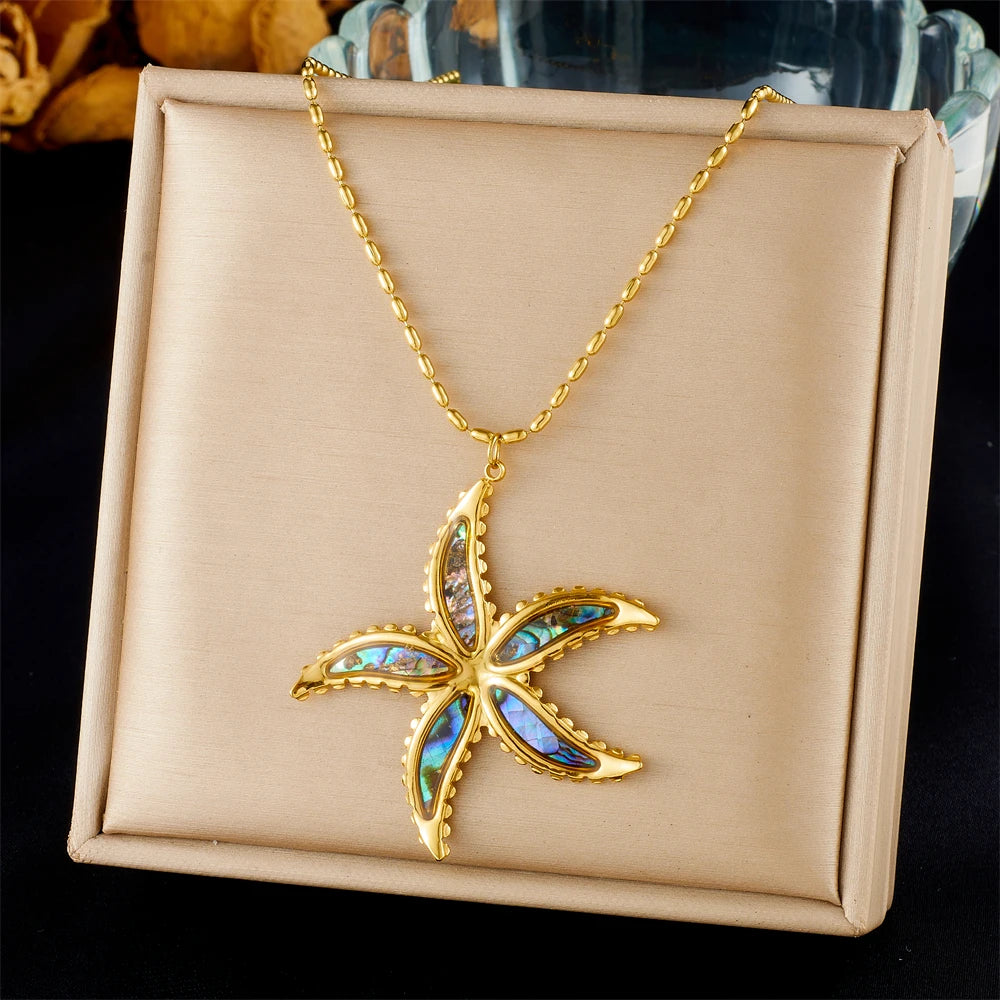 Starfish flower pendant necklace with gold-tone chain and blue enamel charm