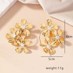 Gold-tone camellia-style flower dangle earrings with faceted petals and hoop frames