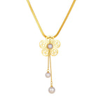 Gold-tone flower pendant necklace with two white pearl drops
