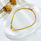 Gold heart charm bracelet with blue and pink enamel heart charms