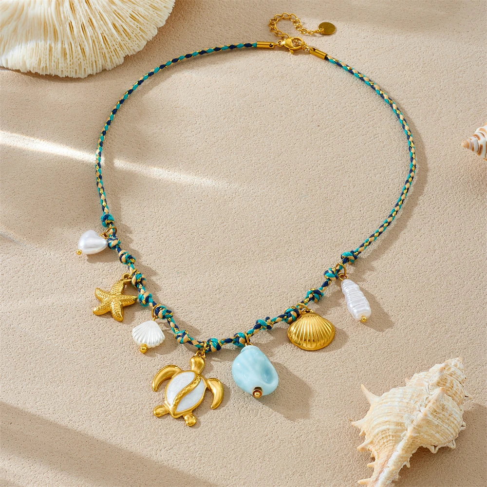 Sea turtle pendant necklace with starfish, pearl shells, and blue stone drops