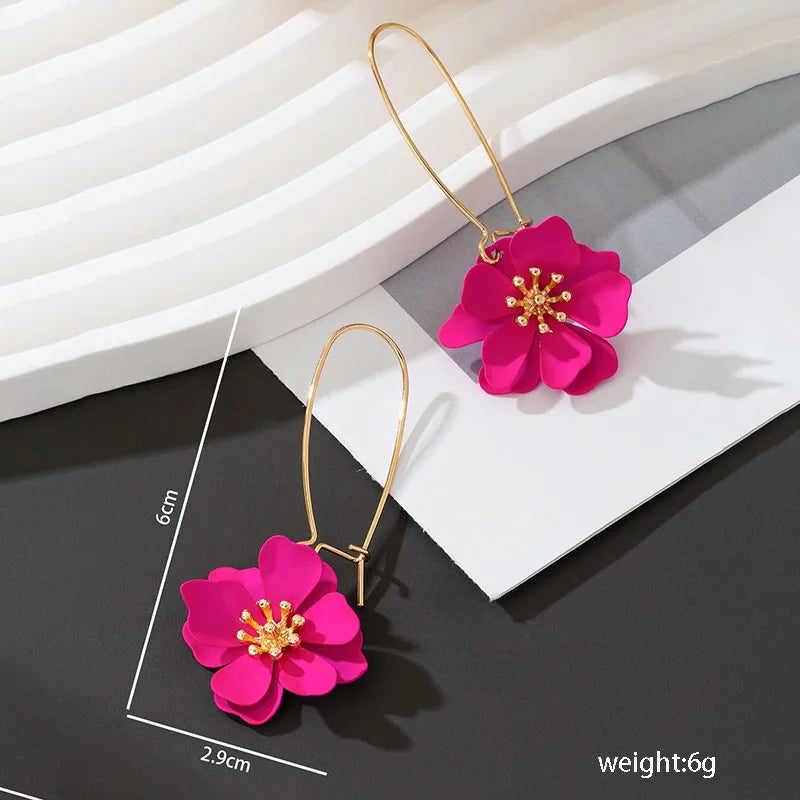 Floral stud earrings with layered hot-pink flower petals and gold-tone hooks