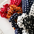 Polka-dot scrunchie scarves in red, orange, navy, black, and white close-up