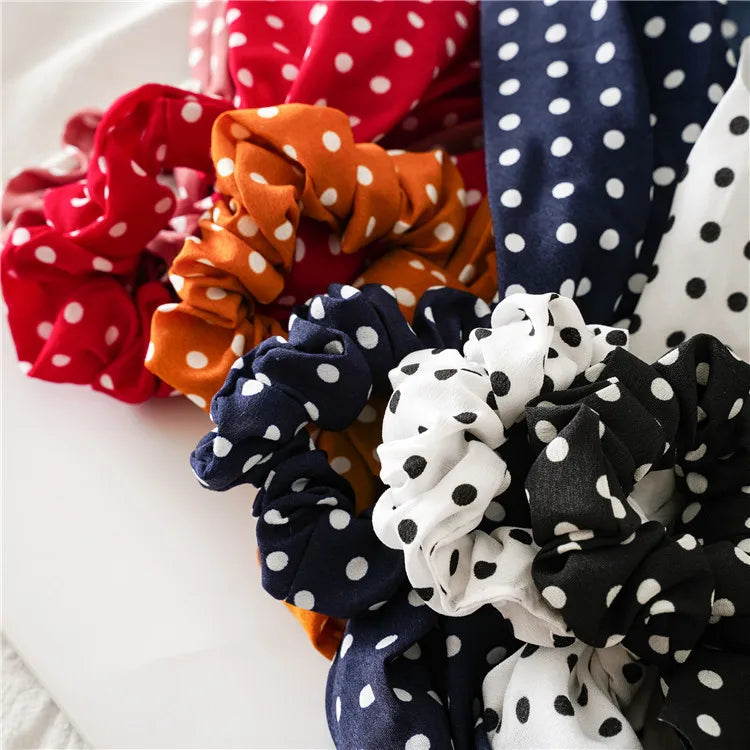 Polka-dot scrunchie scarves in red, orange, navy, black, and white close-up