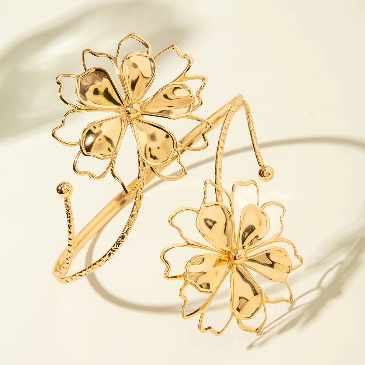 Gold flower upper arm bracelet with large petal blooms and chain cuff strands