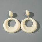 Ivory oval drop earrings with small ivory ball studs and oversized circular ring shapes
