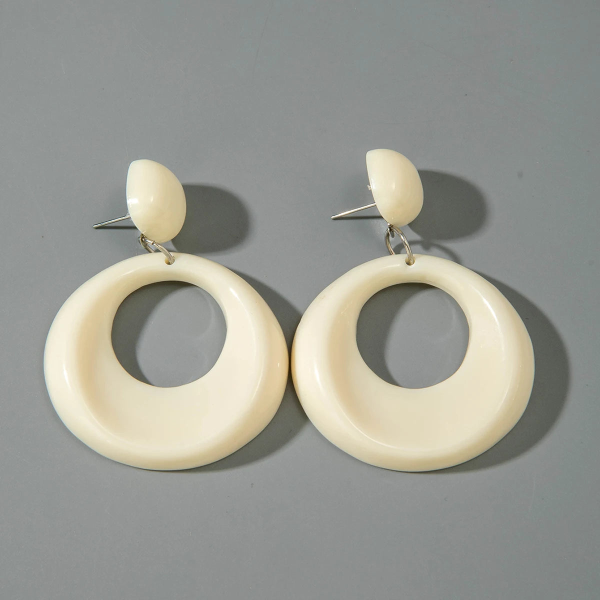 Ivory oval drop earrings with small ivory ball studs and oversized circular ring shapes