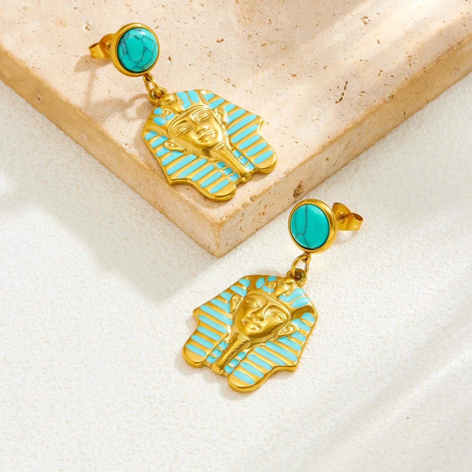 Gold-tone turquoise stud earrings with blue enamel pharaoh head drop charms