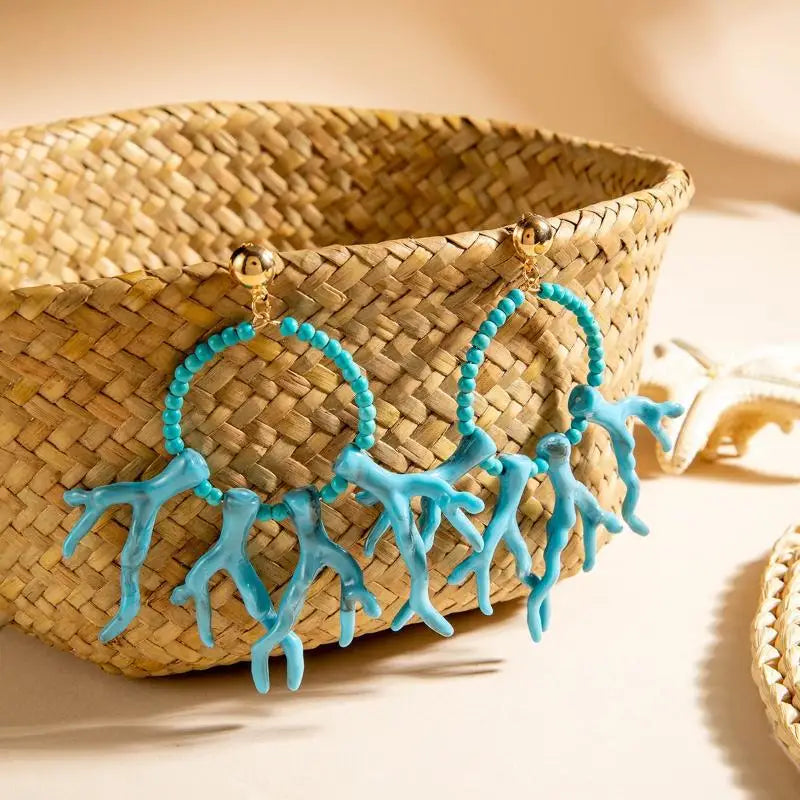 Turquoise acrylic drop earrings with beaded hoops and long dangling fringe