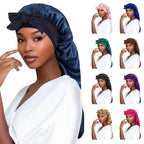 Dark blue satin sleep bonnet with knotted bow and gathered crown on model
