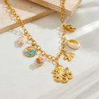 Gold-tone shell charm necklace with octopus pendant, bow charm, and enamel drops.