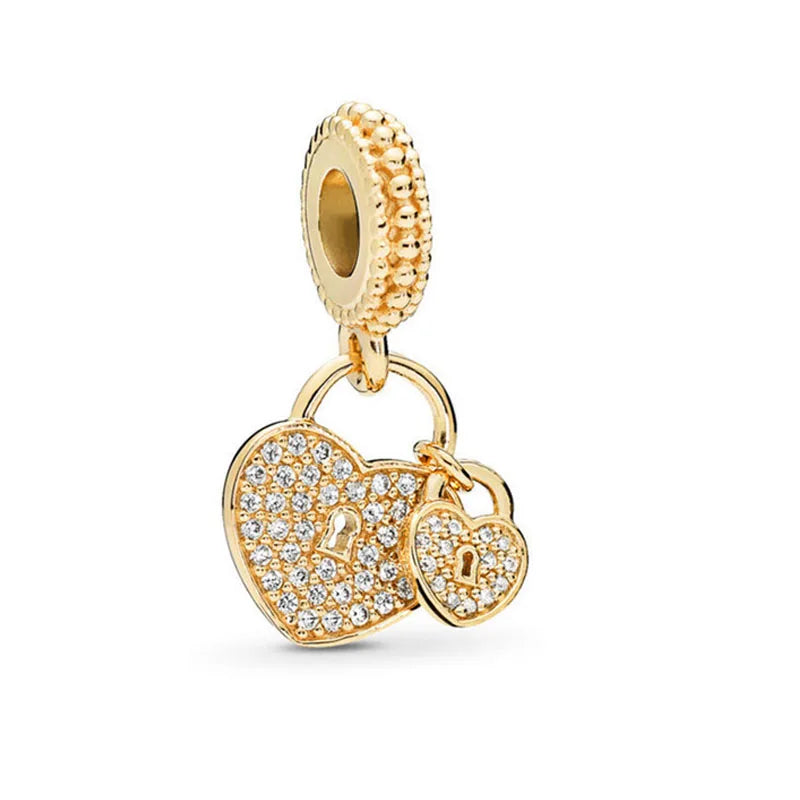 Gold-tone charm bead with heart and small tag accent, set with clear stones