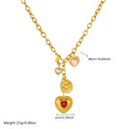 Gold tone pendant necklace with red heart, white pearl heart, and sunburst flower charms