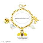 Gold-tone charm bracelet with bee centerpiece, flower dangles, and pearl accents