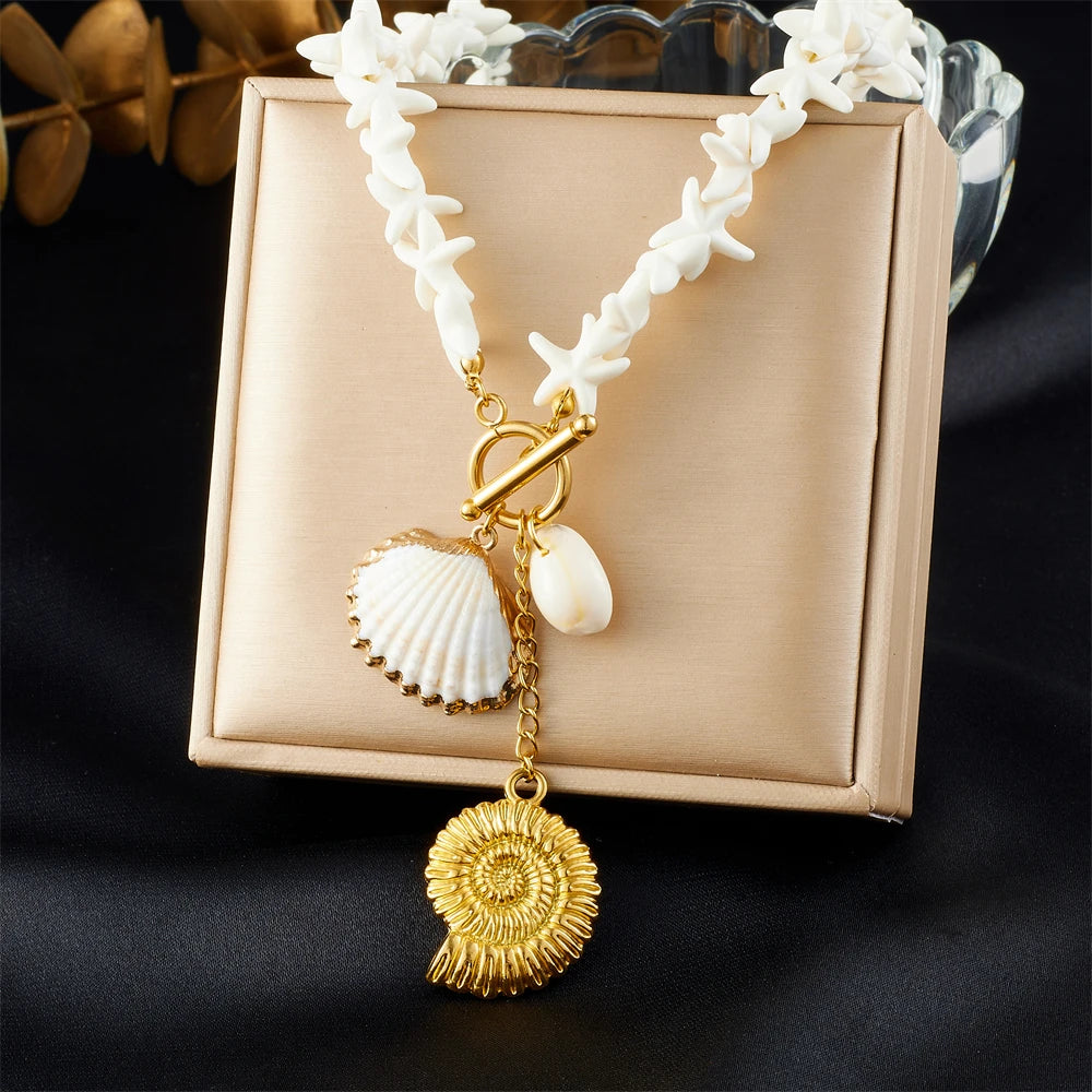 Gold-tone shell pendant necklace with white shell-link chain and conch charm drops