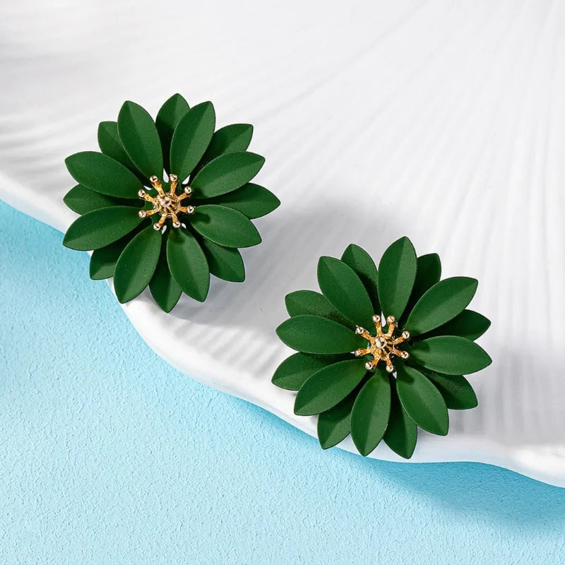 Green enamel flower stud earrings with gold-tone starburst centers