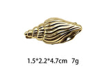 Gold ridged seashell hair clip with hinge barrette backing