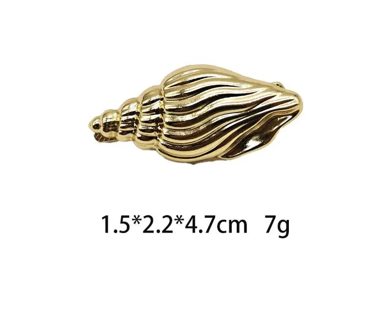 Gold ridged seashell hair clip with hinge barrette backing