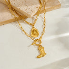 Gold-tone layered chain necklace with cowboy hat and boot charm pendants