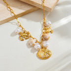 Gold-tone ocean charm necklace with pearl drops and scallop shell, crab, turtle charms