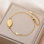 Gold-tone Virgin Mary cross bracelet with oval pendant, cross charm, and chain clasp