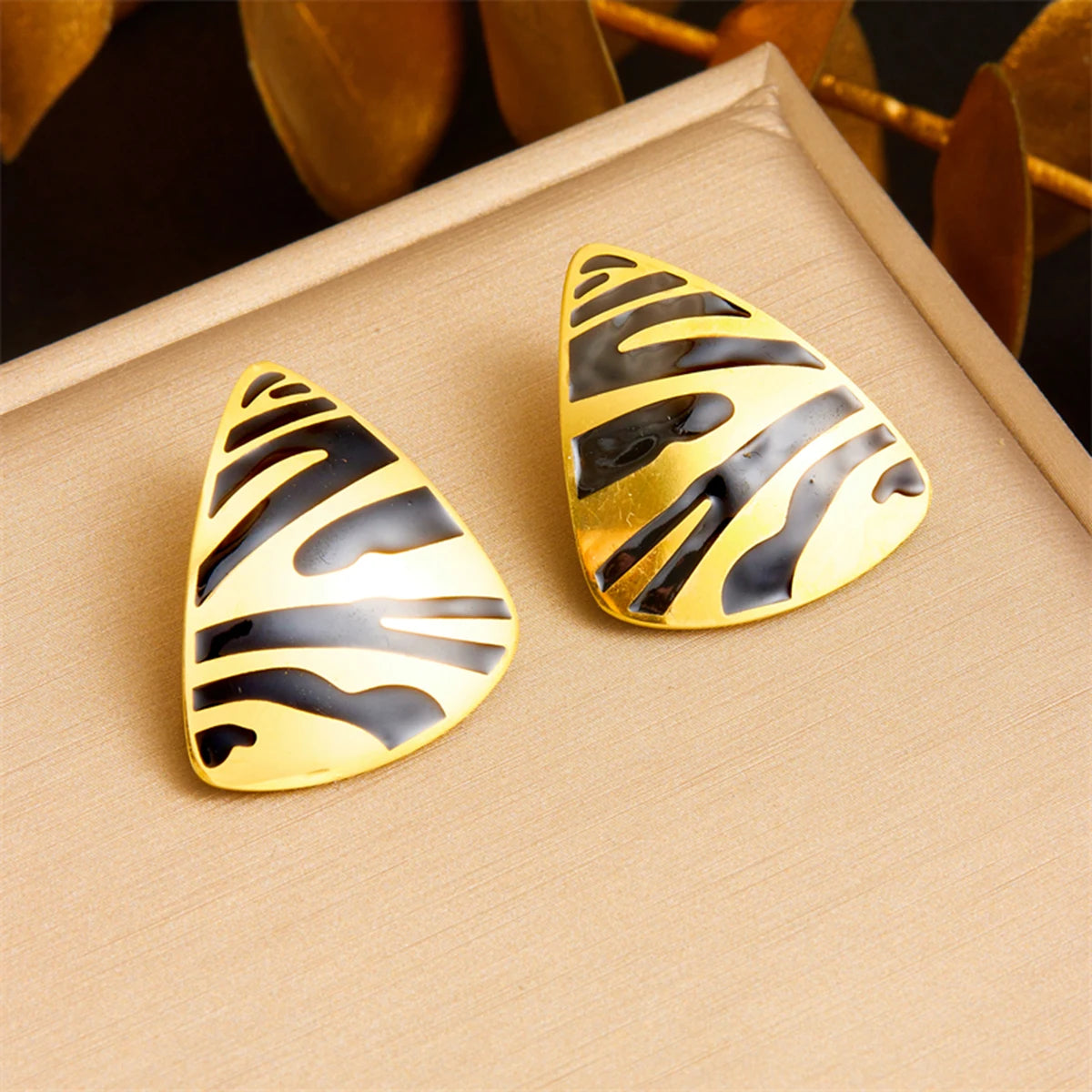 Tiger stripe teardrop earrings pair, white enamel with gold-tone edges and black stripes