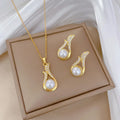 Gold-tone pearl drop pendant necklace with matching teardrop stud earrings