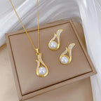 Gold-tone pearl drop pendant necklace with matching teardrop stud earrings