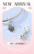 Sterling silver charm with blue evil-eye center and hand-shaped pendant