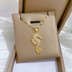 Gold-tone seahorse rhinestone pendant necklace close view on card